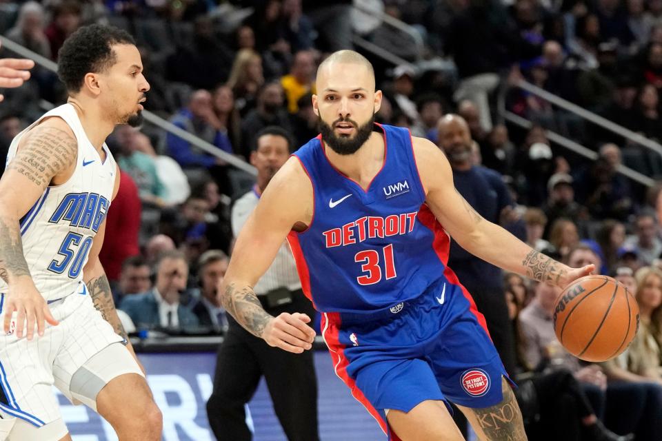 Detroit Pistons guard Evan Fournier (31) controls the ball next to Orlando Magic guard Cole Anthony (50) during the first half at Little Caesars Arena in Detroit on Saturday, Feb. 24, 2024.