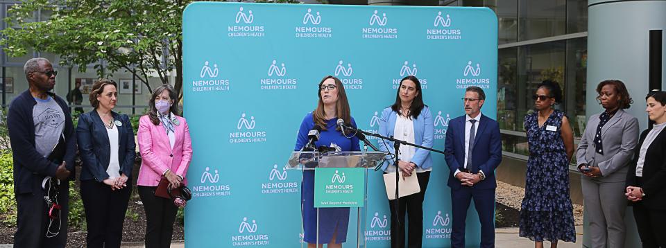 State Sen. Sarah McBride, at the podium, speaks at a press conference on Monday, May 8, 2023, at the Nemours Children's Hospital where legislation was announced that hopes to address lead remediation in homes and schools.