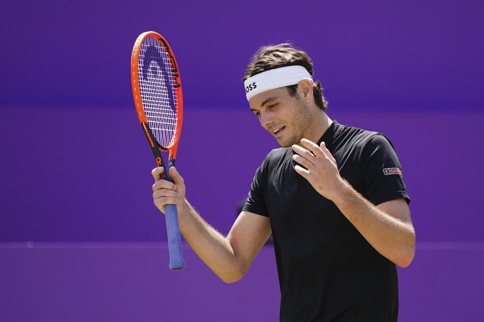 Taylor Fritz of the U.S. reacts during his match against Australia's Jordan Thompson on day seven of the cinch Championships at The Queen's Club, London, Friday June 21, 2024. (Zac Goodwin/PA via AP)