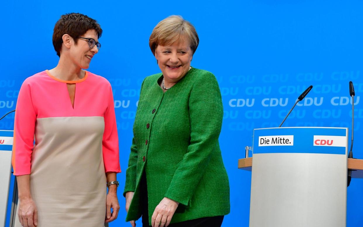 Angela Merkel and Annegret Kramp-Karrenbauer leave after giving a press conference at the CDU headquarters in Berlin on February 19, 2018  - AFP