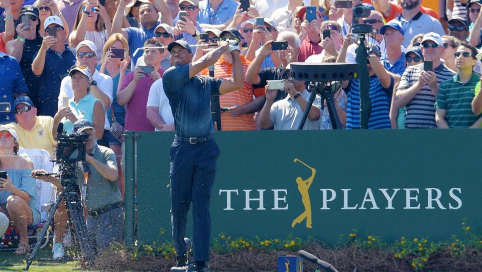 Tiger Woods hits his tee shot at the 17th hole of the Players Stadium Course at the 2018 Players Championship. The tournament returns to full fan capacity this year after its cancellation in 2020 and playing to limited galleries last year.