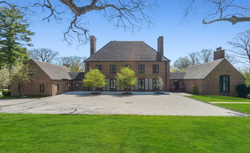 The 2.6-acre spread centers on a 1920s English manor with antique accents and an attic with a wet bar.