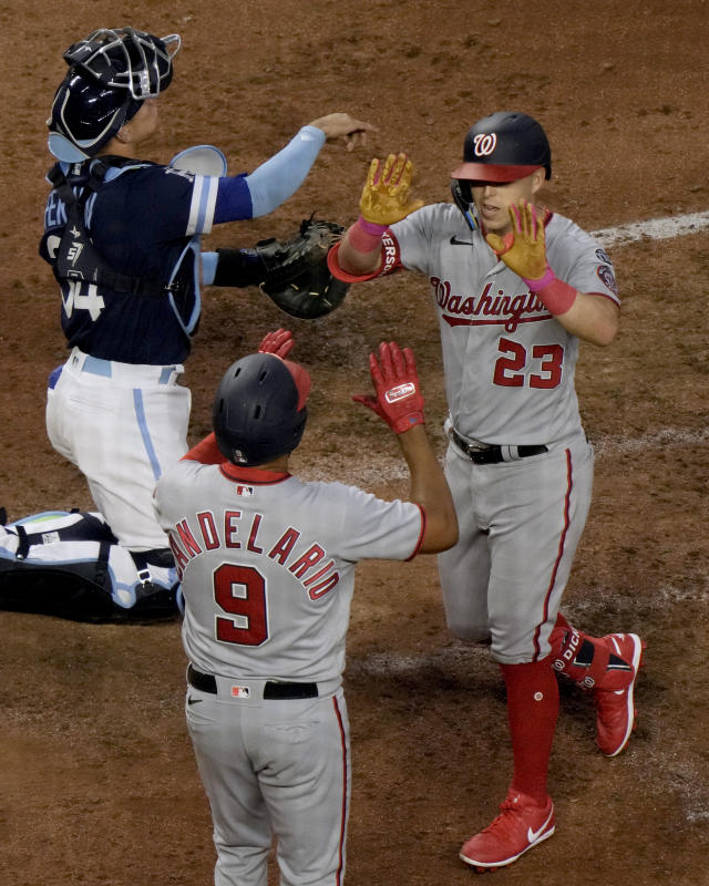 Washington Nationals' Corey Dickerson (23) celebrates with Jeimer Candelario (9) after hitting a three-run home run during the sixth inning of a baseball game against the Kansas City Royals Friday, May 26, 2023, in Kansas City, Mo. (AP Photo/Charlie Riedel)