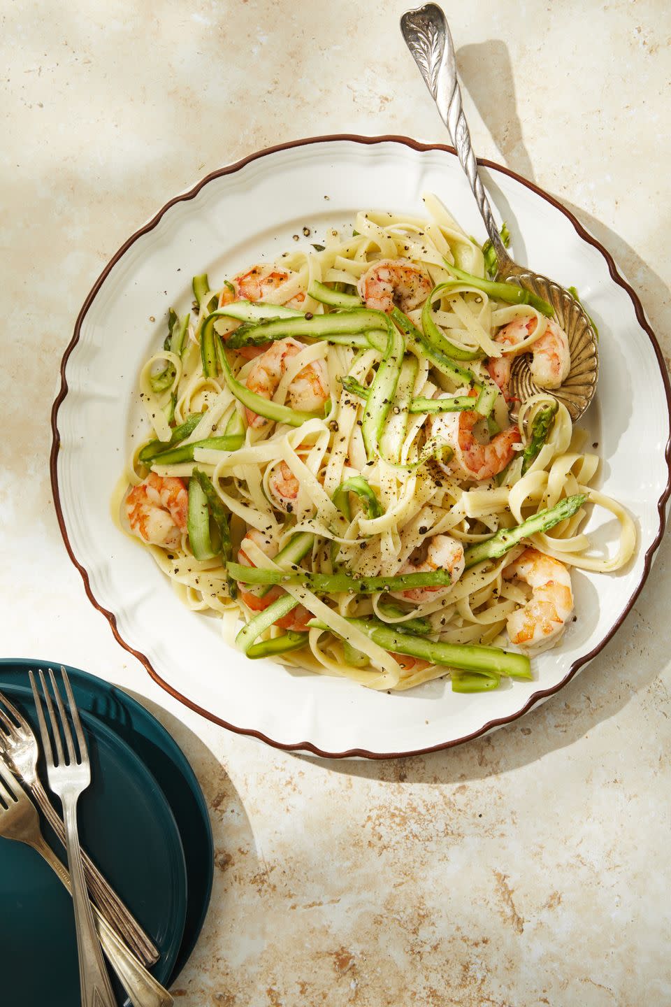 a plate of shrimp and asparagus pasta