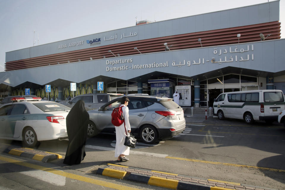 FILE - In this Aug. 22, 2019 file photo, Saudi passengers enter the departure terminal of Abha airport, south of Saudi Arabia. Saudi state TV says on Wednesday, Feb. 10, 2021, that Yemen’s Houthi rebels have targeted Abha International Airport in southwestern Saudi Arabia, causing a civilian plane on the tarmac to catch fire.(AP Photo/Amr Nabil, File)