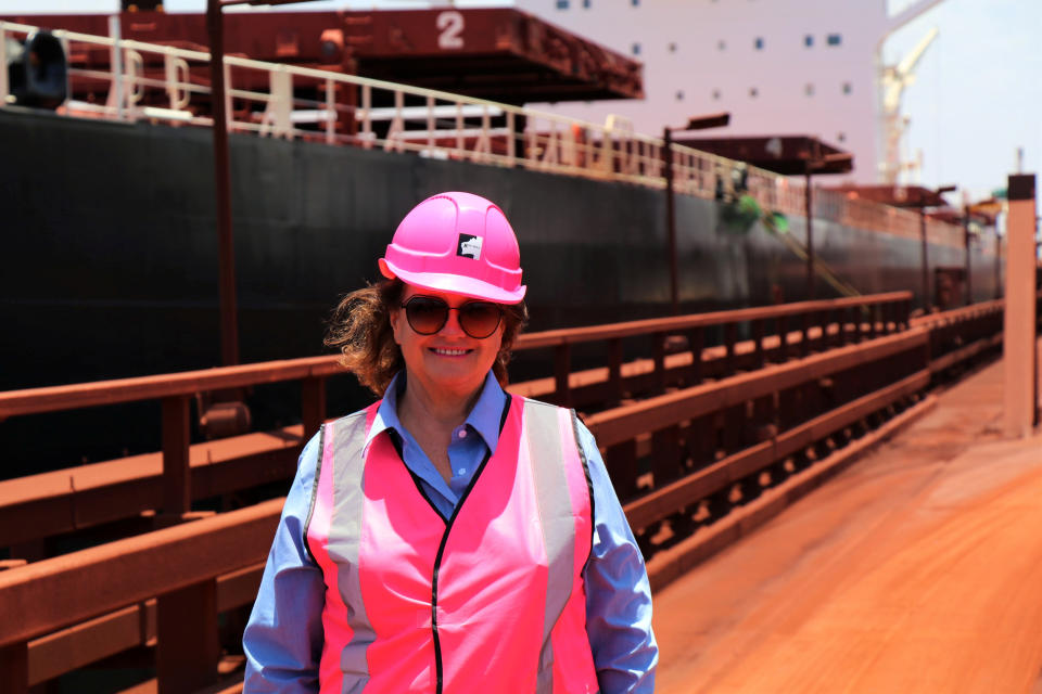 Gina Rinehart poses near a large ship at Roy Hill's berths in Port Hedland.