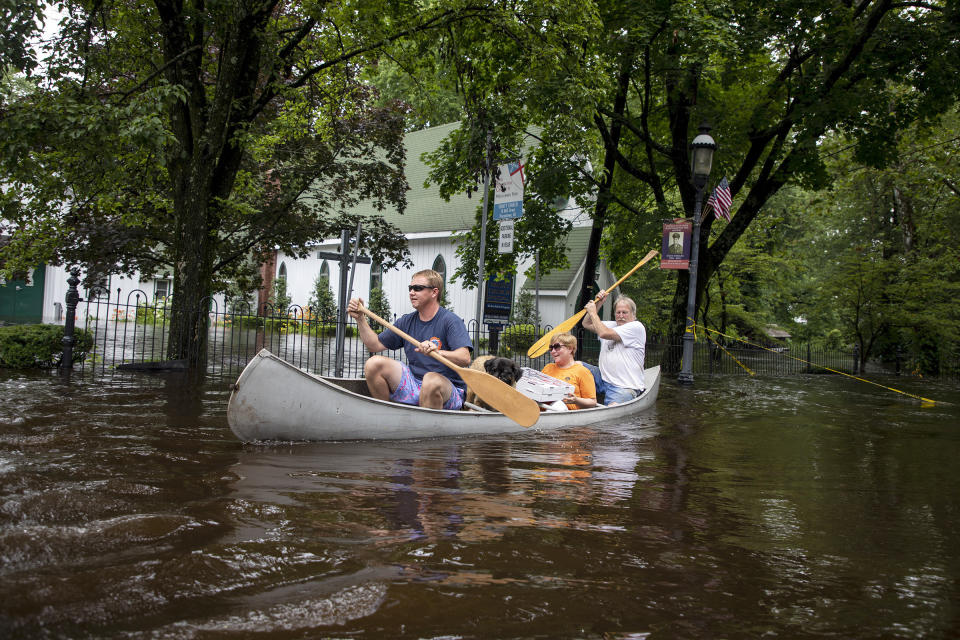 Todd Allen, his dog Rusty with his aunt Betty and uncle Roger Allen, right, of Vincentown, N.J., canoe along flooded roads after heavy rain fell on the area Thursday June 20, 2019. Severe storms containing heavy rains and strong winds have spurred flooding in the suburbs of Philadelphia. (Photo: Tyger Williams/The Philadelphia Inquirer via AP)