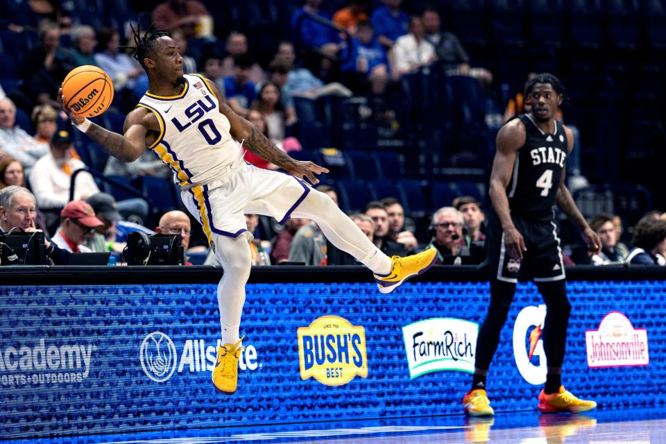 Mar 14; Nashville, Tennessee, United States; LSU guard Trae Hannibal (0) saves the ball from going out of bounds as Mississippi State forward Cameron Matthews (4) watches during a MenÕs SEC Tournament game at Bridgestone Arena in Nashville, Tennessee.