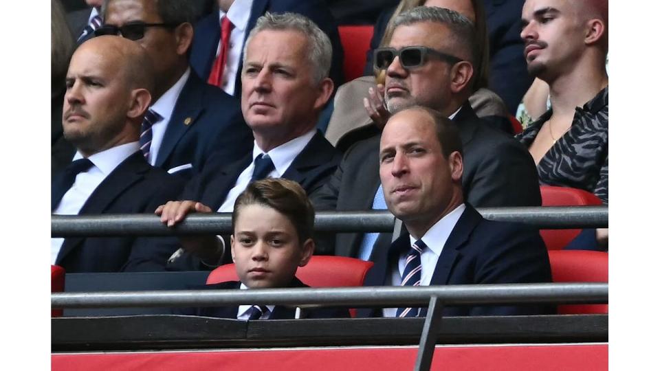 Prince George of Wales (L) and Britain's Prince William, Prince of Wales attend the English FA Cup final football match 