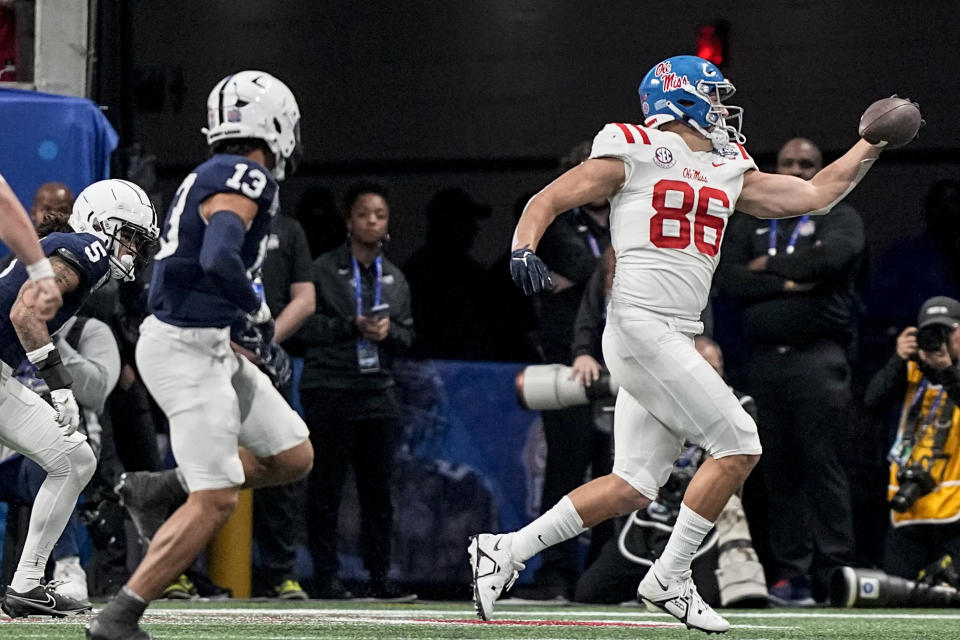 Mississippi tight end Caden Prieskorn (86) makes the catch against Penn State linebacker Tony Rojas (13) during the second half of the Peach Bowl NCAA college football game, Saturday, Dec. 30, 2023, in Atlanta. (AP Photo/Brynn Anderson)