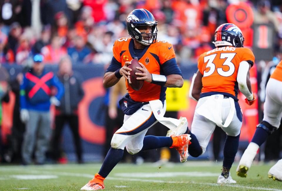 Nov 26, 2023; Denver, Colorado, USA; Denver Broncos quarterback <a class="link " href="https://sports.yahoo.com/nfl/players/25785" data-i13n="sec:content-canvas;subsec:anchor_text;elm:context_link" data-ylk="slk:Russell Wilson;sec:content-canvas;subsec:anchor_text;elm:context_link;itc:0">Russell Wilson</a> (3) scrambles in the first half against the Cleveland Browns at Empower Field at Mile High. Mandatory Credit: Ron Chenoy-USA TODAY Sports