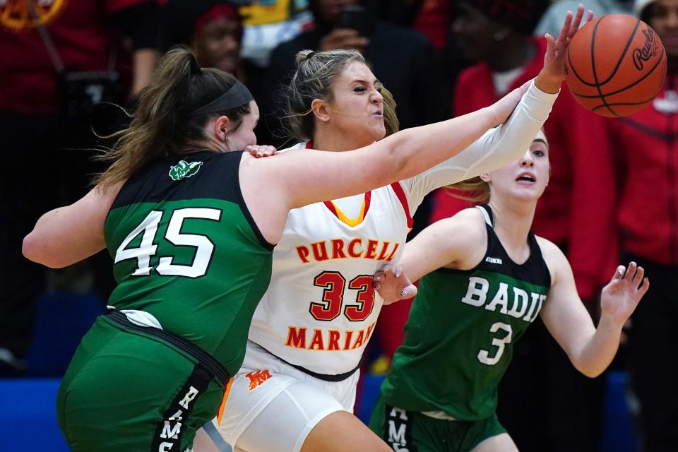 Purcell Marian center Jordan Day competes for a rebound against Badin’s Brooke Sebastian (45) and Hailey Weber (3) in the first half of their Division II girls regional final game March 8 at Springfield.