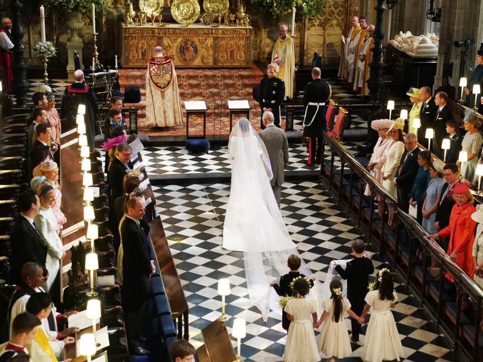 Prince Charles walks Meghan Markle down the aisle at her wedding to Prince Harry at Windsor Castle on May 19, 2018.