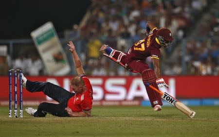 Cricket - England v West Indies - World Twenty20 cricket tournament final - Kolkata, India - 03/04/2016. England's Ben Stokes falls over after colliding with West Indies Dwayne Bravo. REUTERS/Adnan Abidi