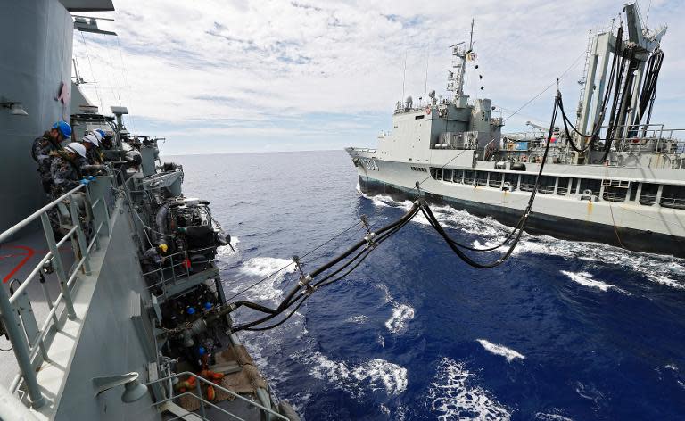 HMAS Perth is refuelled by HMAS Success at sea during the search for missing Malaysia Airlines flight MH370 in the southern Indian Ocean, April 7, 2014