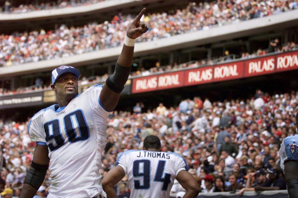 Tennessee Titans defensive end Jevon Kearse (90) acknowledged fans in the stadium moments after teammate Eddie George scored on a touchdown in the fourth quarter to secure a 13-3 victory over the Houston Texans in Houston Dec. 29, 2002. The win in the season final secured the No. 2 AFC seed and a first-round playoff bye.
