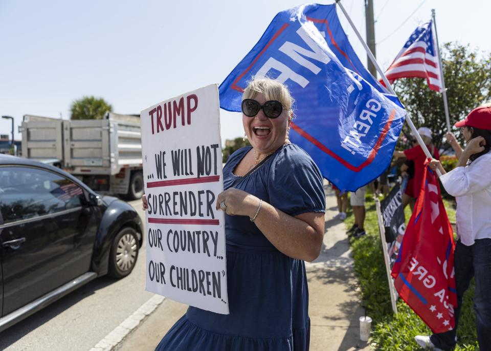 Amy Fredricksen attends a rally before Former President Donald Trump's motorcade makes its way to Palm Beach International Airport on Monday, April 3, 2023, in West Palm Beach, Fla. (Matias J. Ocner/Miami Herald via AP)