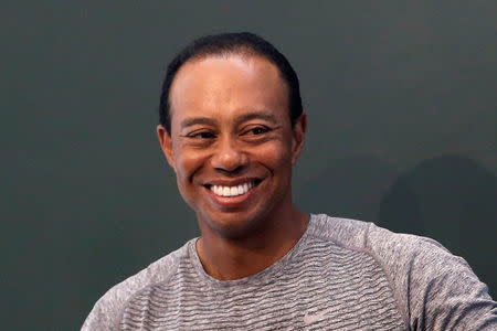 Golfer Tiger Woods smiles as he sits down to sign copies of his new book "The 1997 Masters: My Story" at a book signing event at a Barnes & Noble store in New York City, New York, U.S., March 20, 2017. REUTERS/Mike Segar