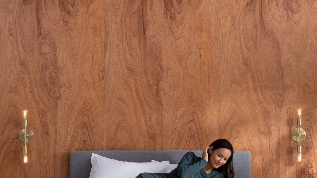 a woman laying on a bed with a book