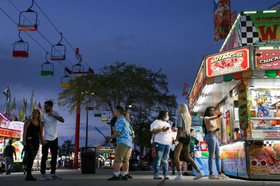 Fairgoers wait in line by the concession stands during the opening day of the Miami-Dade County Youth Fair at the Miami-Dade Fair & Expo Center in Miami, Florida, on Thursday, March 17, 2022.