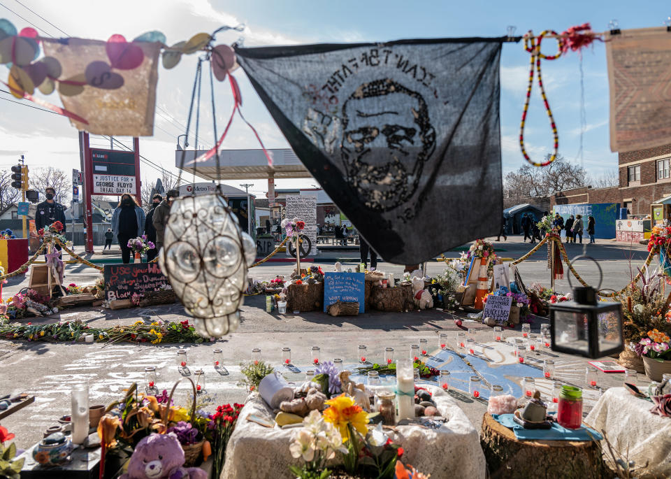 A handkerchief bearing George Floyd's image waves over candles, flowers and other items at the memorials in the square where he was killed in Minneapolis.<span class="copyright">Ruddy Roye for TIME</span>