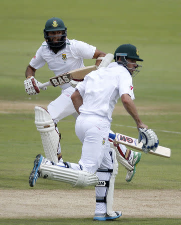 South Africa's Hashim Amla (L) and Stephen Cook make a run during the fourth cricket test match against England in Centurion, South Africa, January 22, 2016. REUTERS/Siphiwe Sibeko