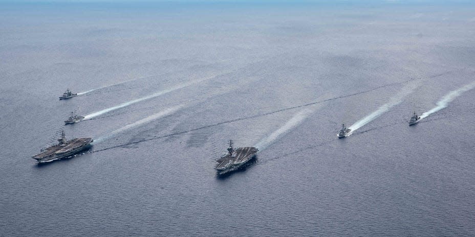 The USS Ronald Reagan (CVN 76) and USS Nimitz (CVN 68) Carrier Strike Groups (CSGs) steam in formation
