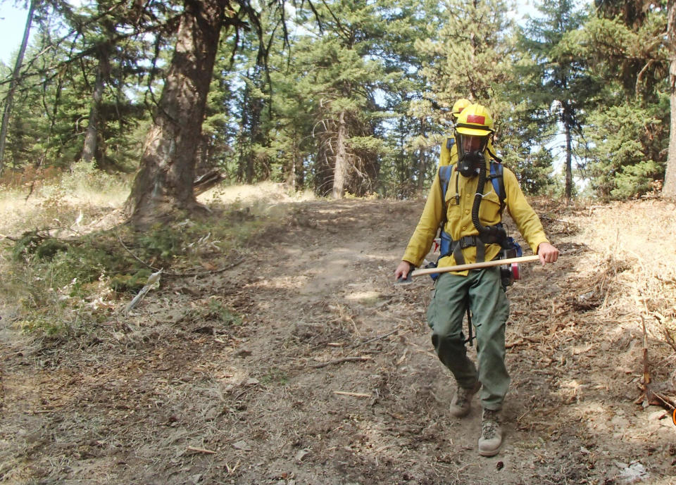 Firefighters wearing respirators in the OU3 area in Montana. (U.S. Forest Service)