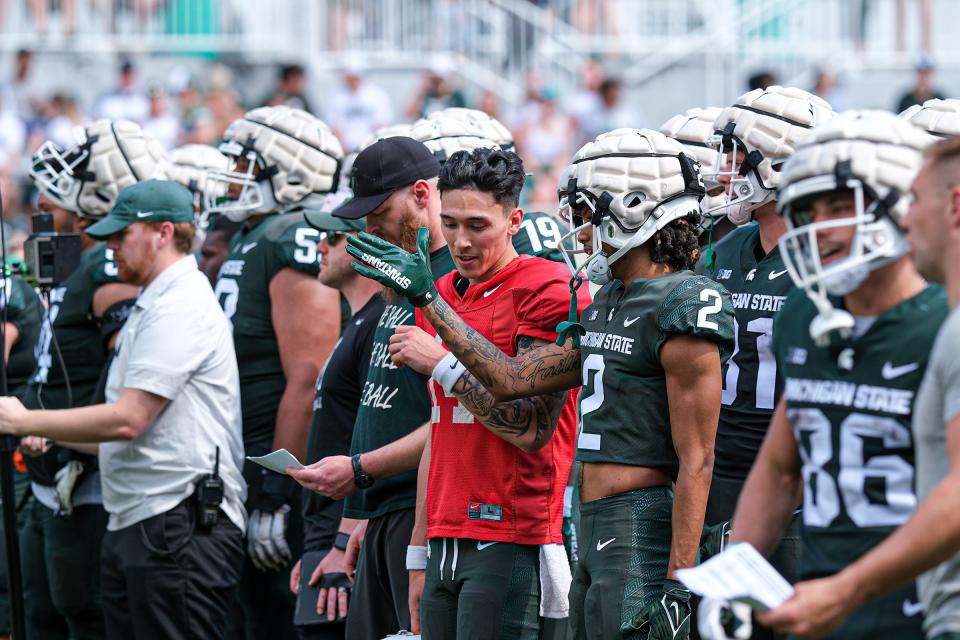 Quarterback Noah Kim (14) talks with wide receiver Tyrell Henry (2) during the Spring Game at Spartan Stadium Saturday, April 15, 2023.