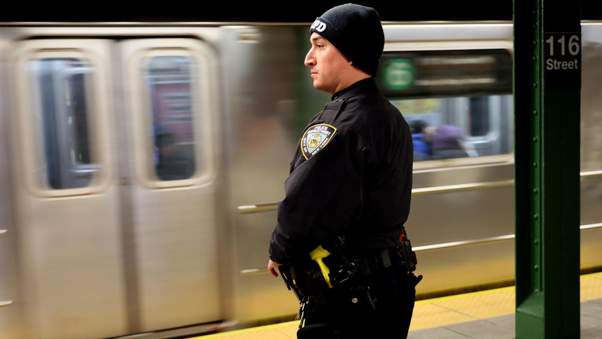 An NYPD Officer is seen at the platform at 116th Street and Lexington Avenue Subway station in New York City.