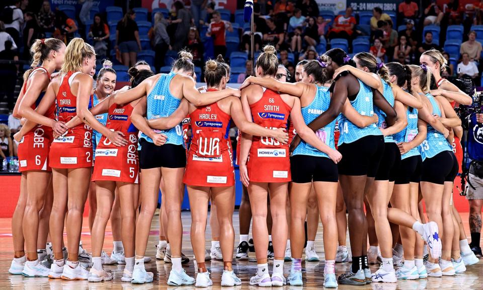 <span>NSW Swifts and Melbourne Mavericks players huddle after a recent Team Girls Cup match at Ken Rosewall Arena.</span><span>Photograph: Jenny Evans/Getty Images for Netball Australia</span>