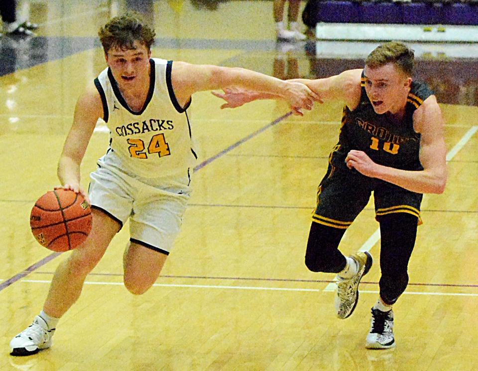 Sioux Valley's Oliver Vincent (24) drives past Groton Area's Lane Tietz during their Class A SoDak 16 state-qualifying boys basketball game on Tuesday, March 7, 2023 in the Watertown Civic Arena.