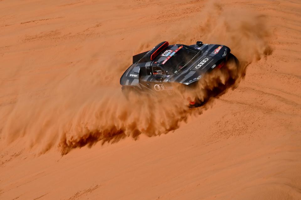 Audi&#39;s electric Spanish driver Carlos Sainz of Spain and co-driver Lucas Cruz of Spain compete during Stage 7 of the Dakar Rally 2022 between the Saudi capital Riyadh and al-Dawadimi town, on January 9, 2022. (Photo by FRANCK FIFE / AFP) (Photo by FRANCK FIFE/AFP via Getty Images)