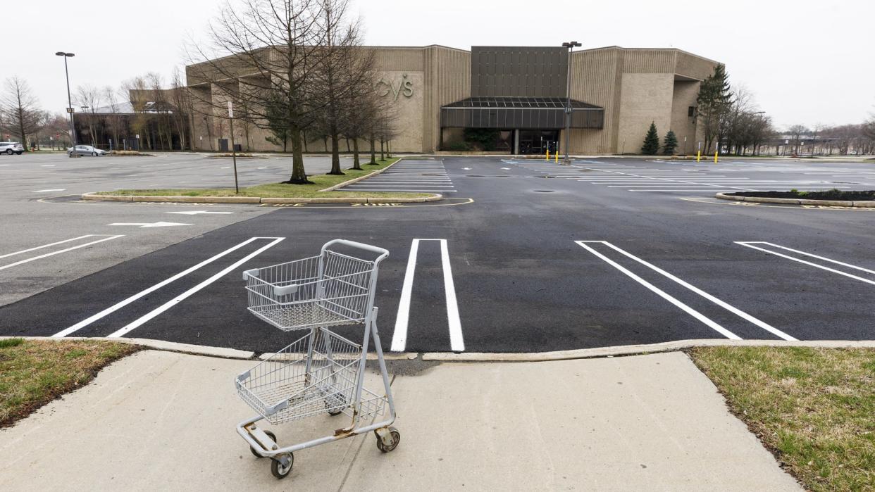 An empty shopping cart in an empty parking lot at a Macy's department store in a mall which is closed to help prevent the spread of the coronavirus, in Paramus, New Jersey, USA, 30 March 2020.