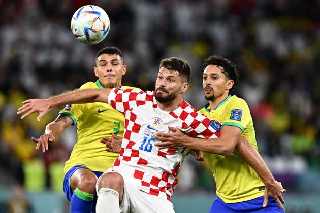 Croatia's forward #16 Bruno Petkovic fights for the ball with Brazil's defender #03 Thiago Silva and Brazil's defender #04 Marquinhos during the Qatar 2022 World Cup quarter-final football match between Croatia and Brazil at Education City Stadium in Al-Rayyan, west of Doha, on December 9, 2022. (Photo by GABRIEL BOUYS / AFP) (Photo by GABRIEL BOUYS/AFP via Getty Images)