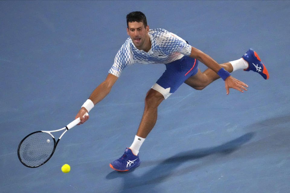 Novak Djokovic of Serbia plays a forehand return to Tommy Paul of the U.S. during their semifinal at the Australian Open tennis championship in Melbourne, Australia, Friday, Jan. 27, 2023. (AP Photo/Ng Han Guan)