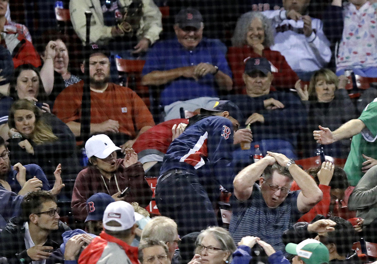 Blue Jays second baseman Devon Travis’ bat flies into the Fenway crowd in the eighth inning on Wednesday night. (AP)