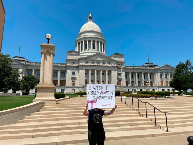 A demonstrator holds a sign outside the Arkansas state Capitol in Little Rock. (Photo: Andrew DeMillo/Associated Press)