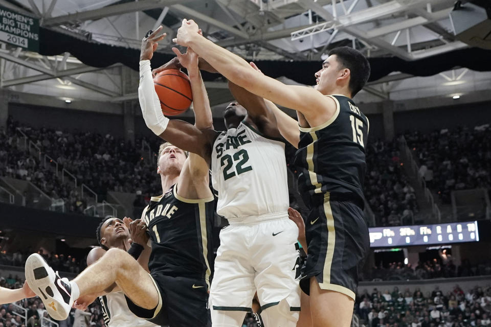 Michigan State center Mady Sissoko (22) and Purdue center Zach Edey (15) and Purdue forward Caleb Furst (1) reach for the rebound during the first half of an NCAA college basketball game, Monday, Jan. 16, 2023, in East Lansing, Mich. (AP Photo/Carlos Osorio)