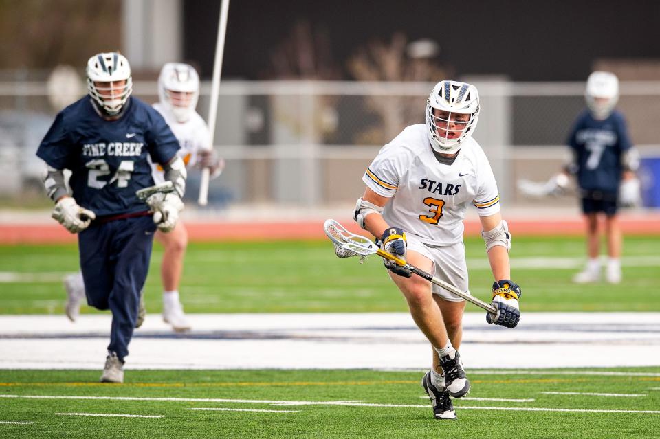 PSD's Jack McKeon brings the ball up field during a Colorado Class 5A boys first-round lacrosse match on Wednesday, May 8, 2024 at PSD Stadium in Timnath, Colo.