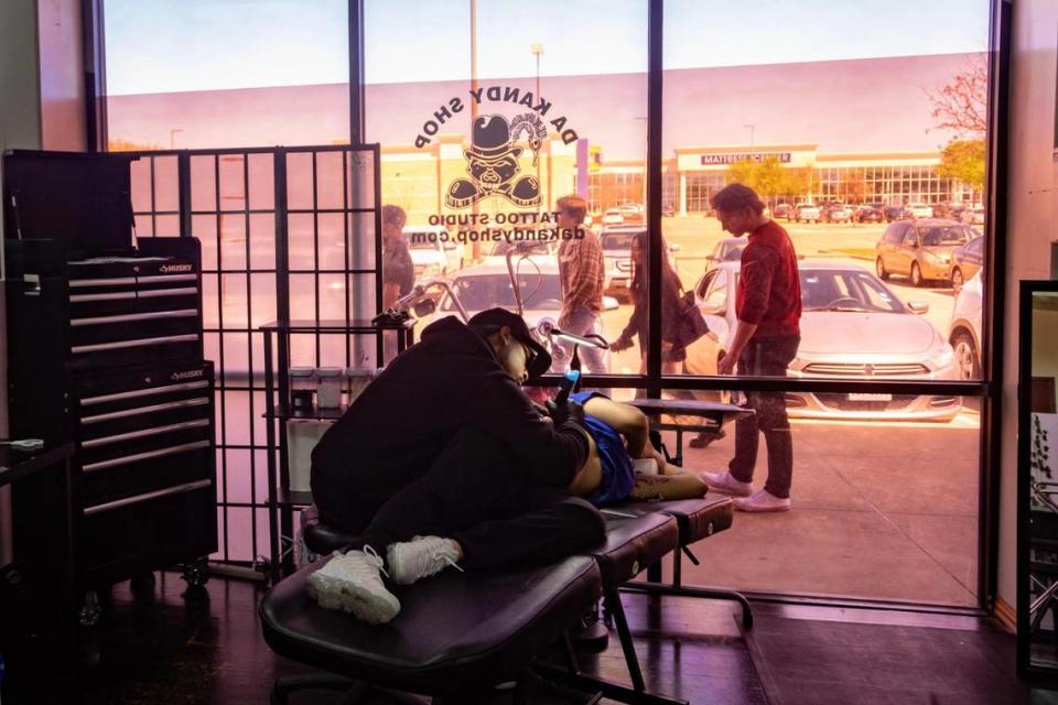 Tattoo artist Carldrick Coleman works on a tattoo at Da Kandy Shop Tattoo Studio on Saturday, March 25, 2023.