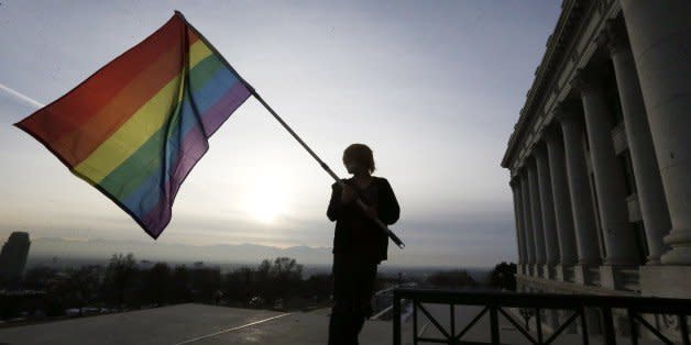 Corbin Aoyagi, a supporters of gay marriage, waves his flag during a rally at the Utah State Capitol, Tuesday, Jan. 28, 2014, in Salt Lake City. Opponents and supporters of gay marriage held twin rallies at the Capitol on Tuesday. More than 1,000 gay couples rushed to get married when a federal judge overturned Utah's constitutional amendment banning same-sex marriage in late December 2013. In early January the U.S. Supreme Court granted Utah's request for an emergency halt to the weddings. (AP Photo/Rick Bowmer) (Photo: )