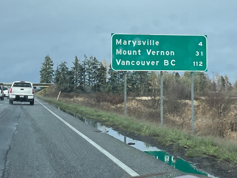 green highway sign on the road from Seattle to Vancouver