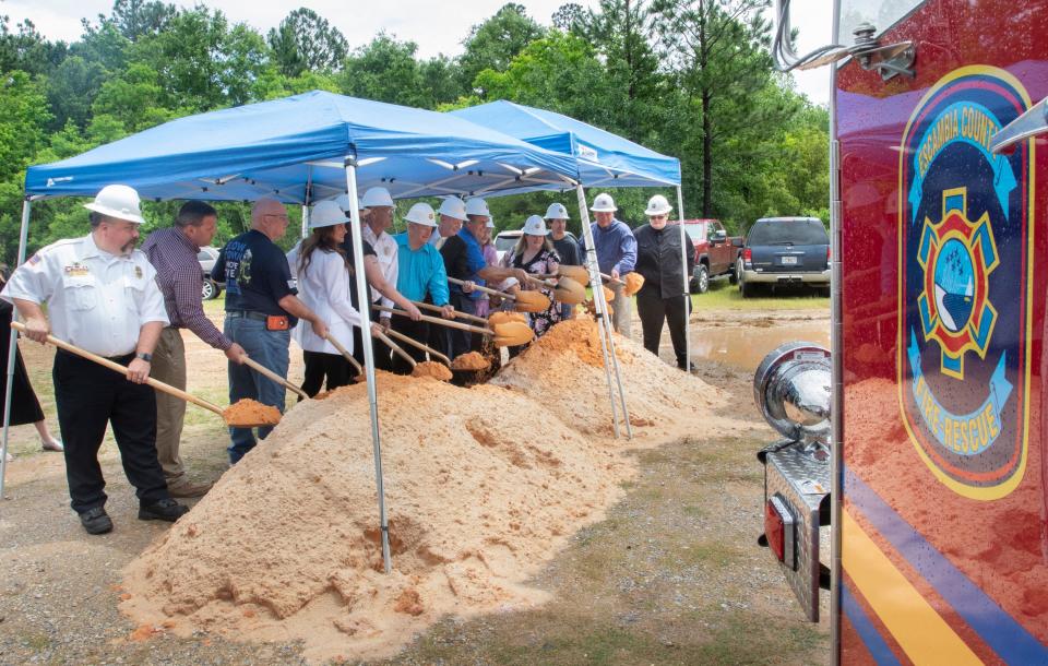 Family members and officials pose for photos during the groundbreaking ceremony for the new Escambia County Fire Rescue Station No. 2 in Beulah on Friday.