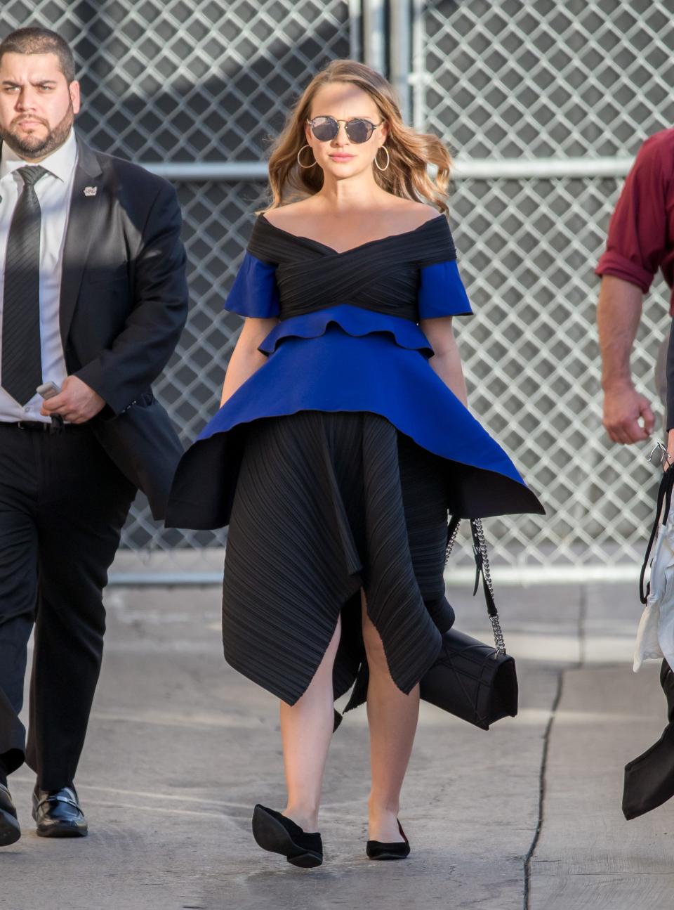 Natalie Portman in a black and blue dress and black flats