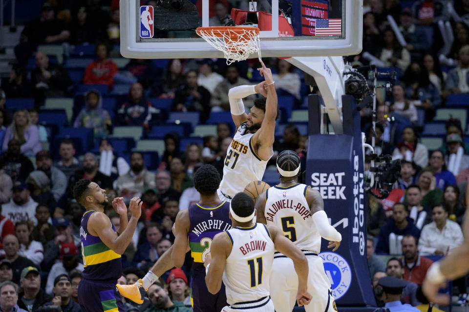 Denver Nuggets guard Jamal Murray (27) dunks next to New Orleans Pelicans guard Trey Murphy III during the first half of an NBA basketball game in New Orleans, Tuesday, Jan. 24, 2023. (AP Photo/Matthew Hinton)