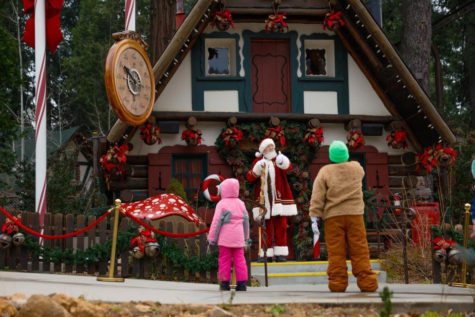 Santa Claus chats with young visitors at his house in Skypark at Santa's Village.