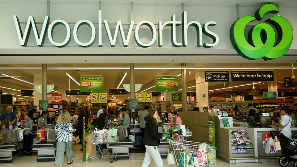 People shop at a Woolworths supermarket in Sydney on March 17, 2020. - Australia's elderly were let in early to supermarkets on March 17, but coronavirus panic buying still proved too much in some areas, with reports of empty shelves and large queues.