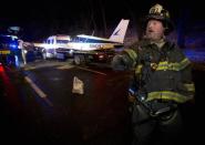 A single engine plane is loaded onto a flat bed truck after landing on Major Deegan Expressway in the Bronx borough of New York January 4, 2014. REUTERS/Carlo Allegri