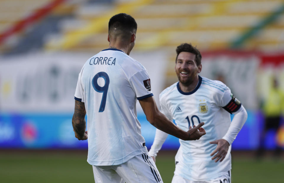 Argentina's Joaquin Correa celebrates scoring his side's second goal against Bolivia with teammate Lionel Messi during a qualifying soccer match for the FIFA World Cup Qatar 2022 in La Paz, Bolivia, Tuesday, Oct. 13, 2020. (AP Photo/Juan Karita)